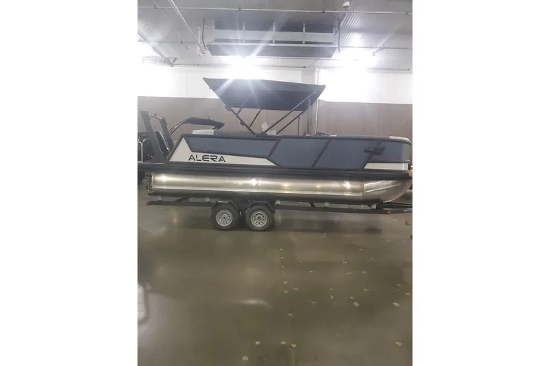 Slide: The Image of 2027 Alera M21Q pontoon boat on trailer in indoor showroom. - 7