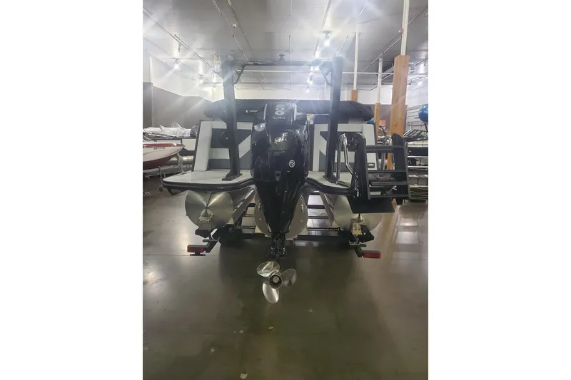 Slide: The Image of 2027 Alera M21Q boat in showroom, rear view with motor and propeller. - 5