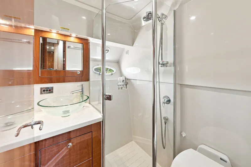 Slide: The Image of Luxurious bathroom in 2009 Riviera 4700 Sport Yacht with glass sink and modern shower. - 21