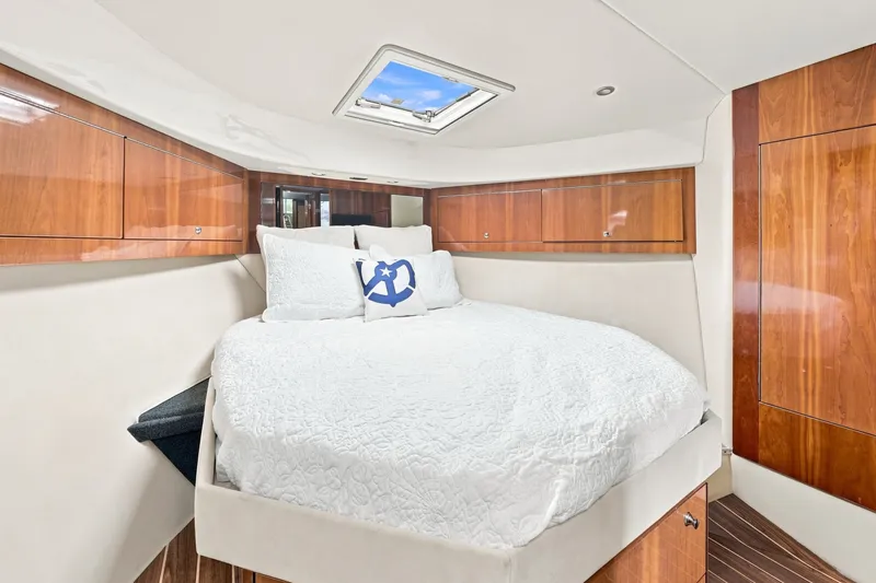 Slide: The Image of Luxurious cabin interior of 2009 Riviera 4700 Sport Yacht with elegant wood finishes. - 20