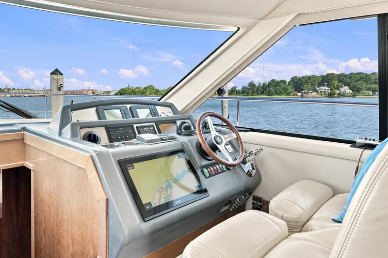 Slide: The Image of Interior view of 2009 Riviera 4700 Sport Yacht helm with navigation system. - 16
