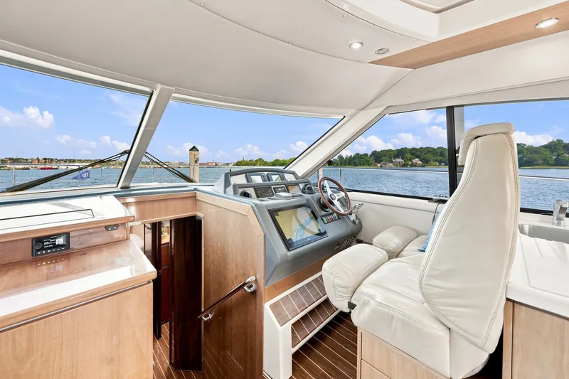 Slide: The Image of Interior of 2009 Riviera 4700 Sport Yacht with luxurious helm and scenic water view. - 15
