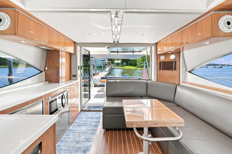 Slide: The Image of Luxurious interior of 2009 Riviera 4700 Sport Yacht with modern kitchen and seating area. - 10