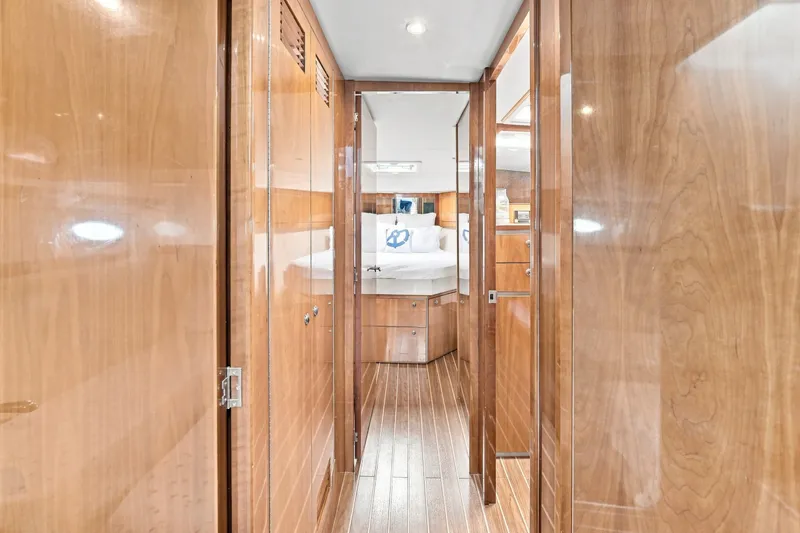 Slide: The Image of Interior of 2009 Riviera 4700 Sport Yacht with polished wood finish and cozy bedroom. - 18