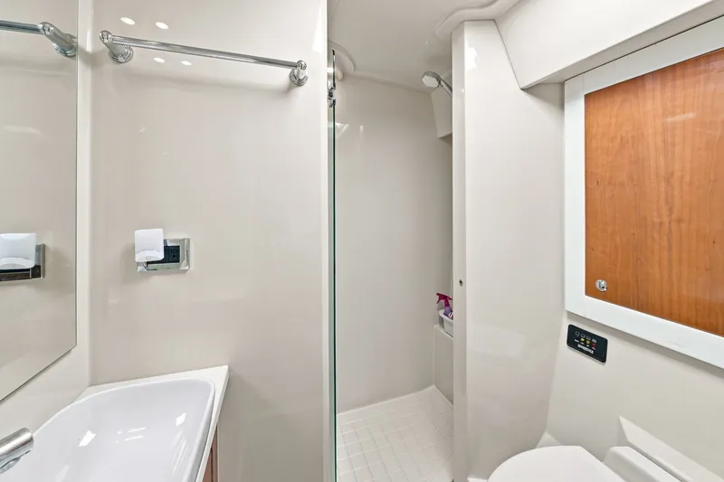 Slide: The Image of Luxurious bathroom interior of 2009 Riviera 4700 Sport Yacht, featuring modern fixtures and sleek design. - 26