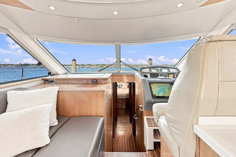 Slide: The Image of Interior view of 2009 Riviera 4700 Sport Yacht with luxurious seating and navigation system. - 17