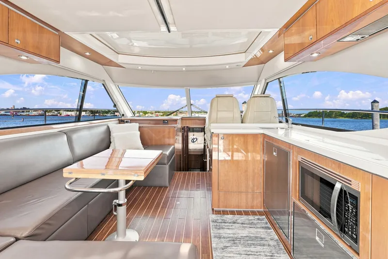 Slide: The Image of Luxurious interior of 2009 Riviera 4700 Sport Yacht with modern amenities and scenic ocean view. - 9