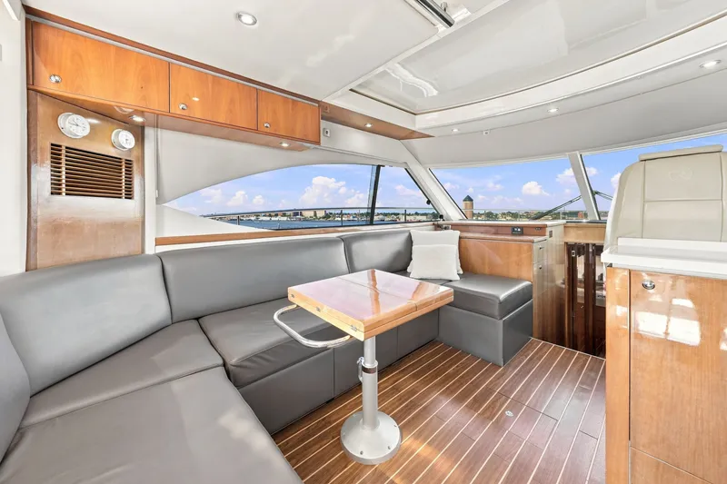 Slide: The Image of Luxurious interior of 2009 Riviera 4700 Sport Yacht with sleek seating and wooden finishes. - 12