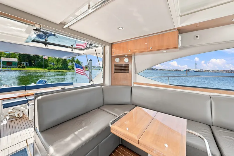 Slide: The Image of Interior of 2009 Riviera 4700 Sport Yacht with lake view and American flag. - 13