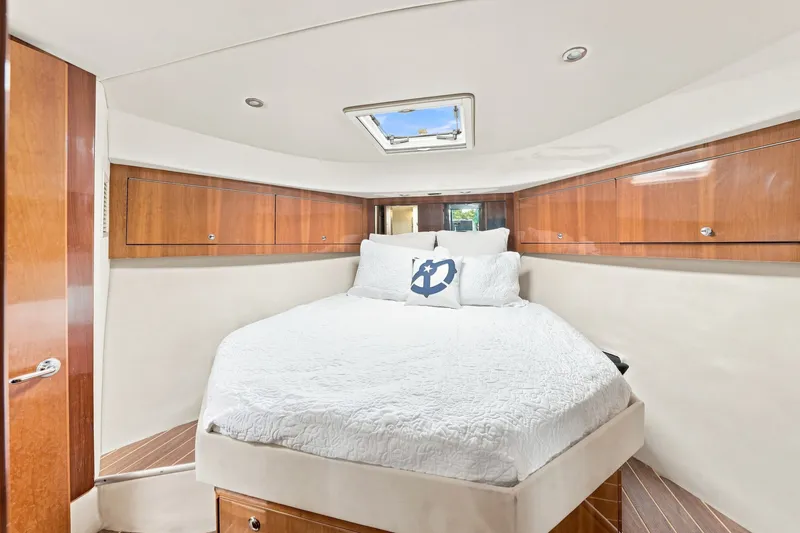Slide: The Image of Luxurious bedroom interior of 2009 Riviera 4700 Sport Yacht with elegant wood finishes. - 19