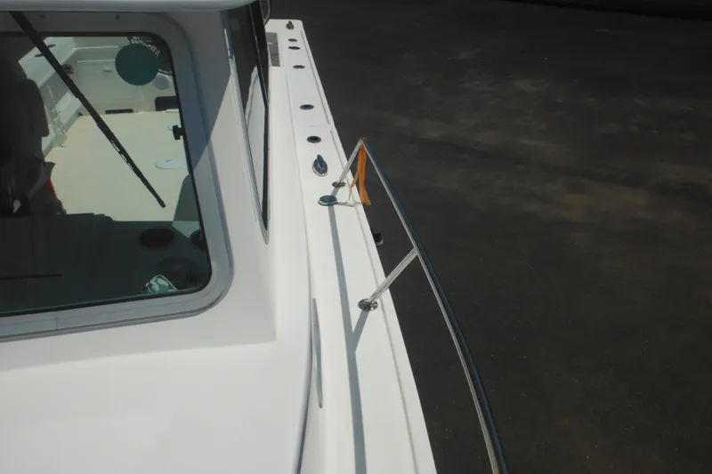 Slide: The Image of 2020 Steiger Craft 255 Miami boat deck with railing and cabin window. - 22