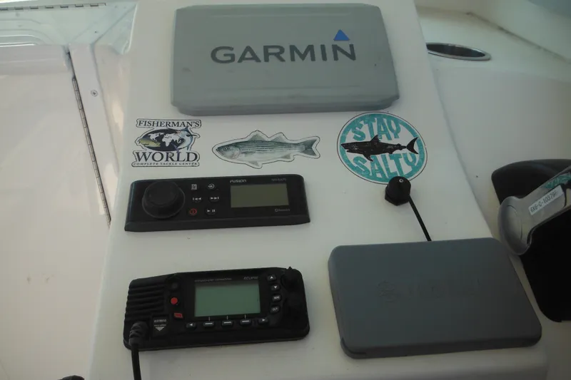 Slide: The Image of Control panel of a 2020 Steiger Craft 255 Miami boat with Garmin equipment and fishing stickers. - 51