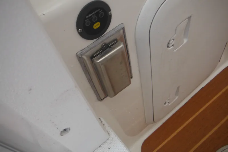 Slide: The Image of Steiger Craft 255 Miami 2020 boat interior detail with control panel and storage compartment. - 16