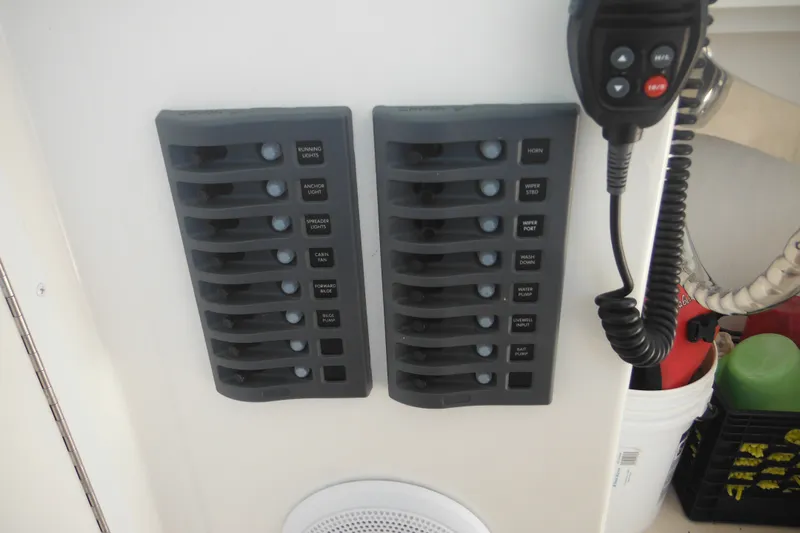 Slide: The Image of Control panel of a 2020 Steiger Craft 255 Miami boat with labeled switches and microphone. - 54