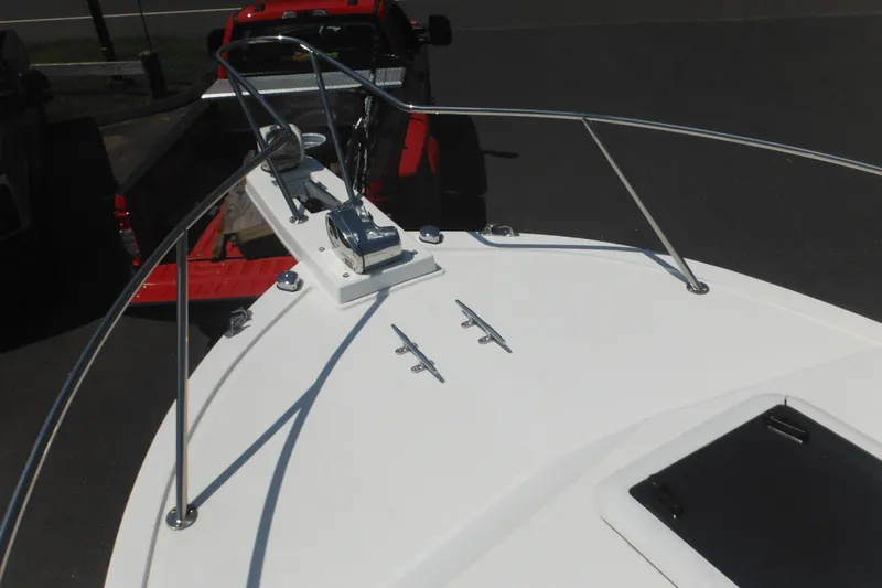 Slide: The Image of 2020 Steiger Craft 255 Miami boat bow with railing and anchor, parked on a trailer. - 19