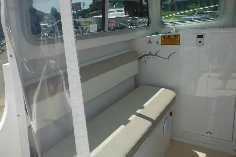 Slide: The Image of Interior view of 2020 Steiger Craft 255 Miami boat, featuring seating and warning labels. - 31