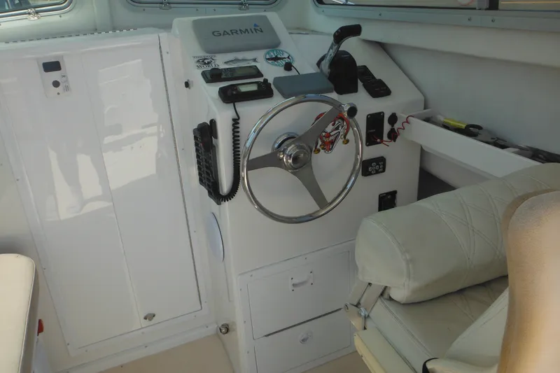 Slide: The Image of Steiger Craft 255 Miami 2020 boat helm with Garmin navigation system and steering wheel. - 48
