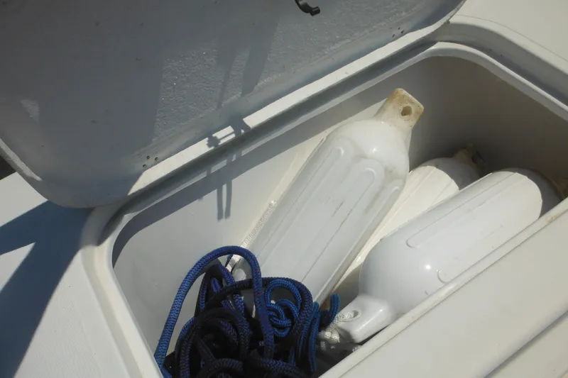 Slide: The Image of Open storage compartment on 2020 Steiger Craft 255 Miami with fenders and rope. - 47