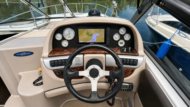 Slide: The Image of The cockpit of a 2006 Four Winns 278 Vista with a modern navigation system and classic gauges. - 3
