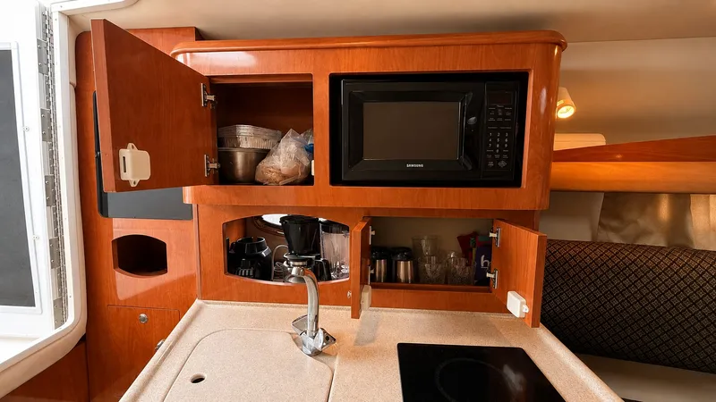 Slide: The Image of The galley of a 2006 Four Winns 278 Vista with microwave, sink, and storage. - 10