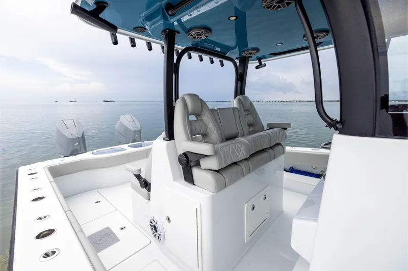 Slide: The Image of 2025 Freeman 35 boat interior with luxurious seating and dual engines on calm water. - 26