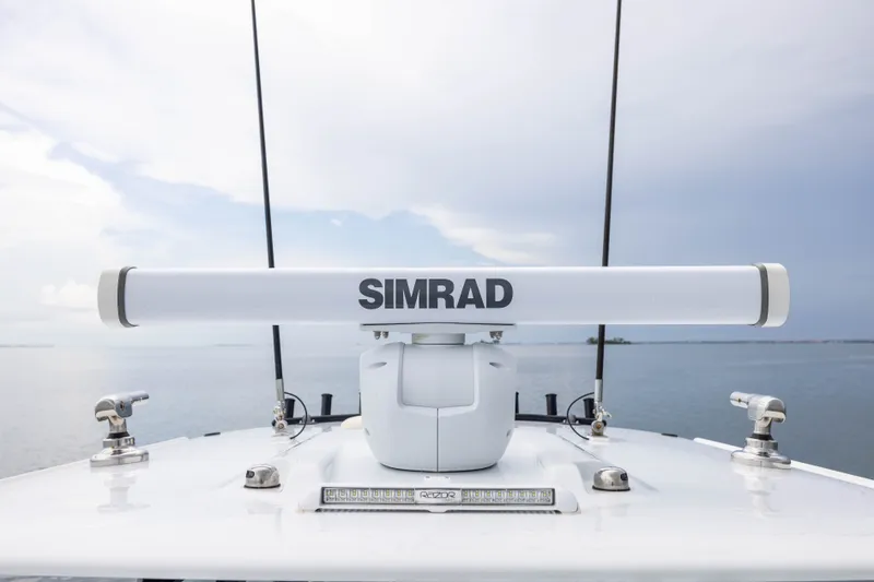 Slide: The Image of Simrad radar on Freeman 35 boat, 2025 model, against a serene ocean backdrop. - 23