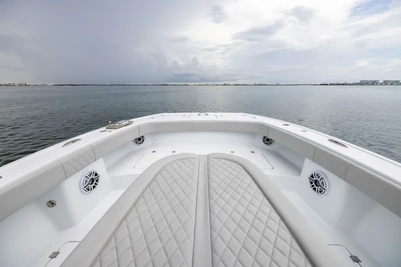 Slide: The Image of Luxurious 2025 Freeman 35 boat interior with quilted seating, overlooking calm waters. - 15