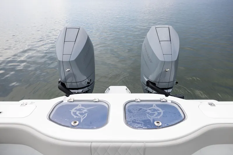 Slide: The Image of 2025 Freeman 35 boat with dual outboard motors on calm water. - 47