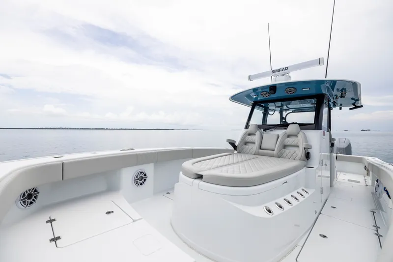 Slide: The Image of 2025 Freeman 35 boat with luxurious seating on calm waters under a cloudy sky. - 18