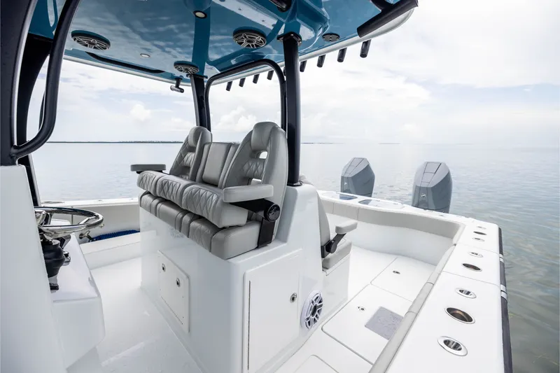 Slide: The Image of 2025 Freeman 35 boat interior with seating and dual outboard motors on calm water. - 25