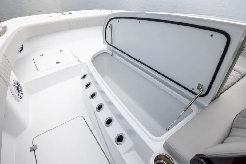 Slide: The Image of 2025 Freeman 35 boat interior with open storage compartment and sleek white design. - 21