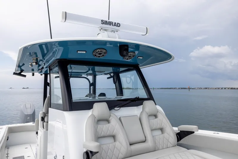Slide: The Image of 2025 Freeman 35 boat with modern helm, luxurious seating, and Simrad electronics on calm water. - 22