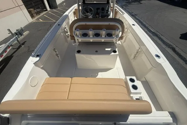 Slide: The Image of 2026 Bayliner Trophy T22CX boat interior with beige seating and rod holders. - 7