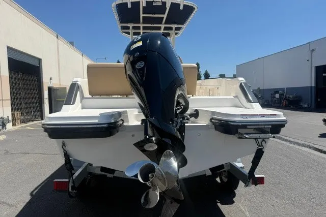 Slide: The Image of 2026 Bayliner Trophy T22CX boat with powerful outboard motor, parked outdoors. - 6