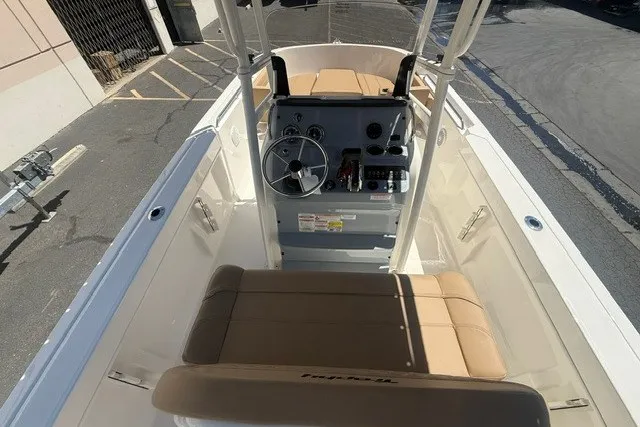 Slide: The Image of 2026 Bayliner Trophy T22CX boat interior with steering console and seating. - 9
