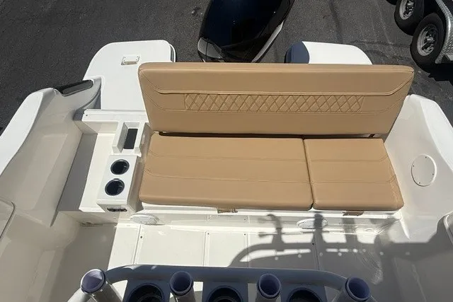 Slide: The Image of 2026 Bayliner Trophy T22CX boat interior with tan seating and cup holders. - 1