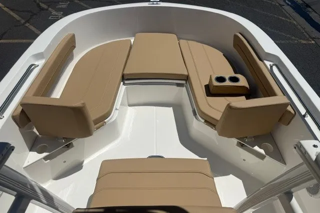 Slide: The Image of 2026 Bayliner Trophy T22CX boat interior with tan seating and cup holders. - 12
