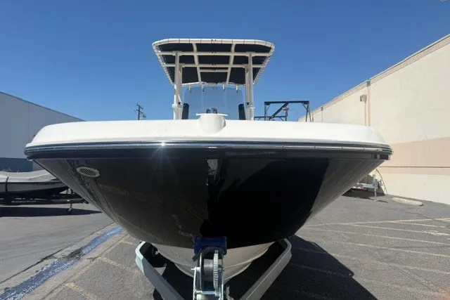 Slide: The Image of 2026 Bayliner Trophy T22CX boat on trailer, front view, outdoors. - 22