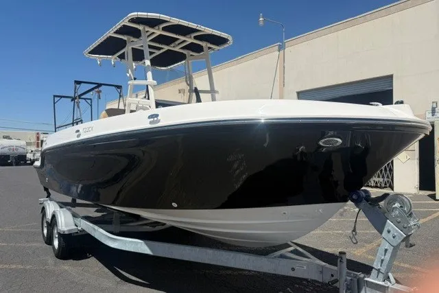 Slide: The Image of 2026 Bayliner Trophy T22CX boat on trailer, black hull, outdoor setting. - 4