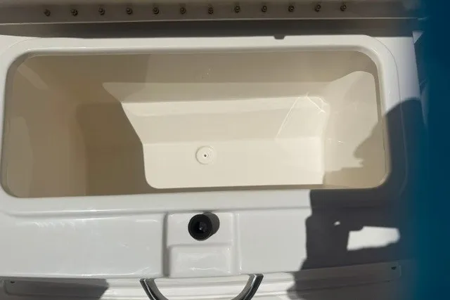 Slide: The Image of 2026 Bayliner Trophy T22CX boat storage compartment, open and empty, with white interior. - 17