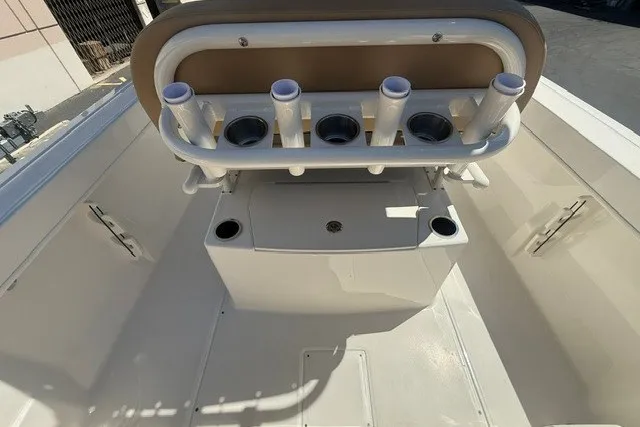 Slide: The Image of 2026 Bayliner Trophy T22CX boat interior with rod holders and storage compartments. - 8