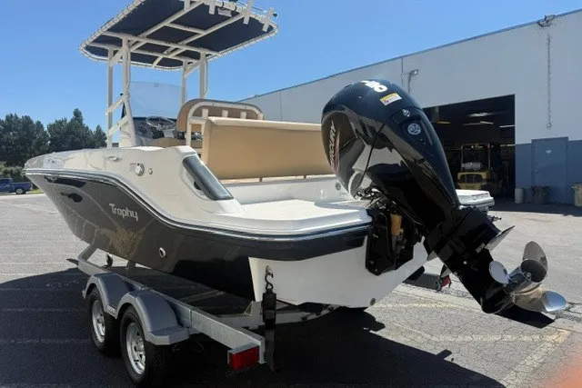 Slide: The Image of 2026 Bayliner Trophy T22CX boat on trailer, featuring a powerful outboard motor. - 3