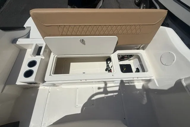 Slide: The Image of 2026 Bayliner Trophy T22CX boat interior with storage compartments and cup holders. - 19