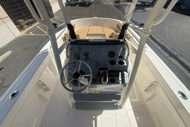 Slide: The Image of 2026 Bayliner Trophy T22CX boat cockpit with steering wheel and control panel. - 10