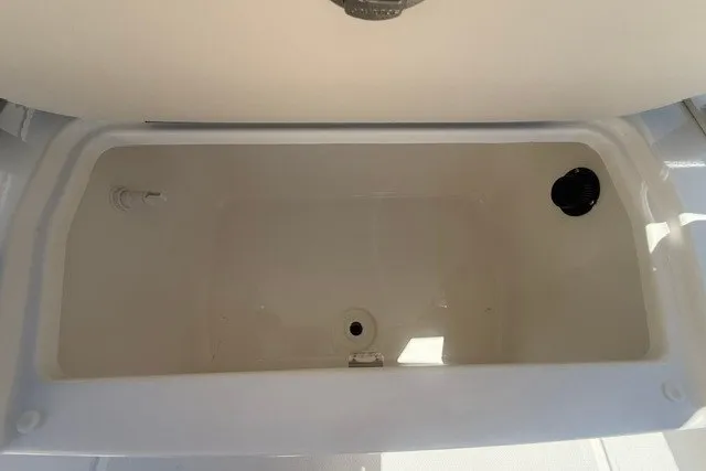 Slide: The Image of Livewell compartment in 2026 Bayliner Trophy T22CX boat, open lid view. - 18