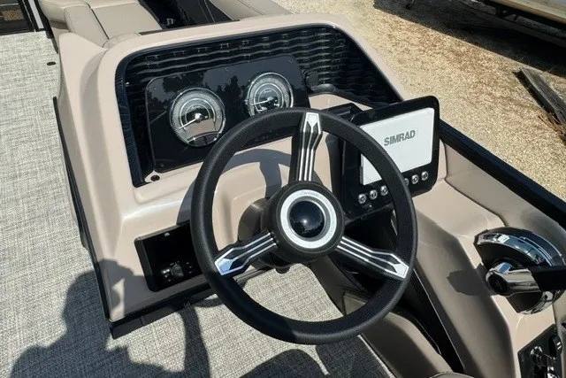 Slide: The Image of Steering console of 2027 Barletta Aria 24UC with Simrad display and gauges. - 16