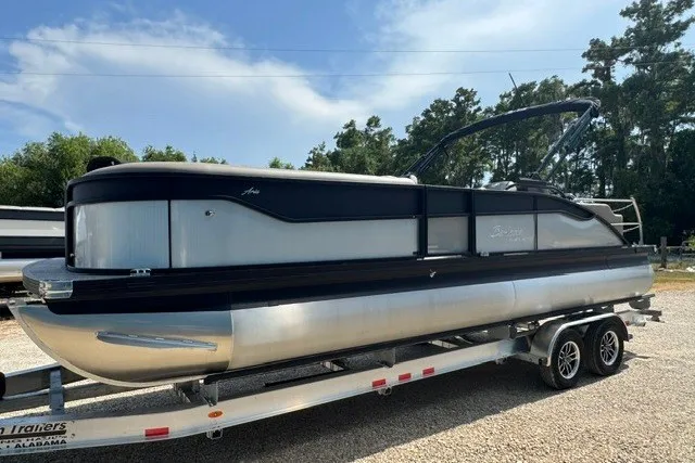 Slide: The Image of 2027 Barletta Aria 24UC pontoon boat on trailer, parked outdoors. - 7
