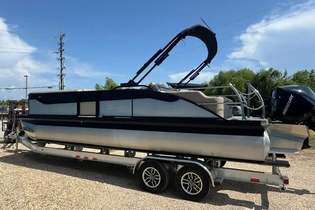 Slide: The Image of 2027 Barletta Aria 24UC pontoon boat on trailer, featuring sleek design and modern amenities. - 6
