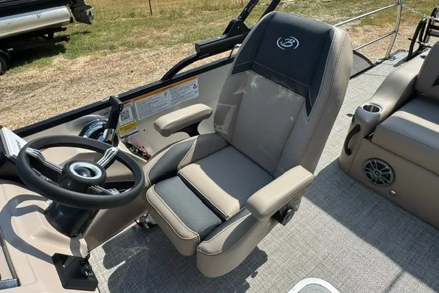 Slide: The Image of 2027 Barletta Aria 24UC boat interior with steering wheel and captain's chair. - 15