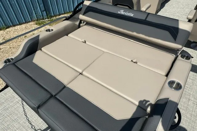 Slide: The Image of 2027 Barletta Aria 24UC boat seating with beige and black upholstery, featuring cup holders. - 19